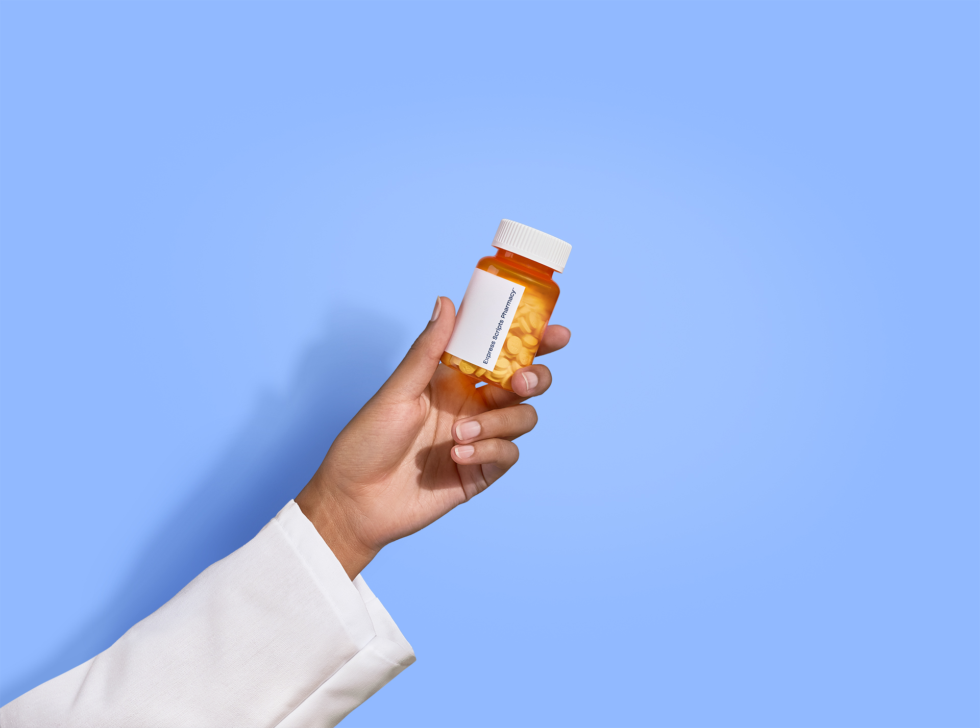 Pharmacist hand holding pill bottle